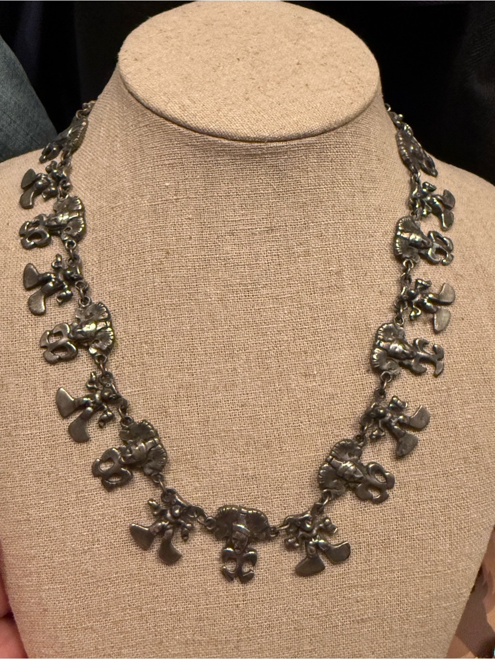 Vintage 1960s pewter tone necklace with alternating tribal figures.